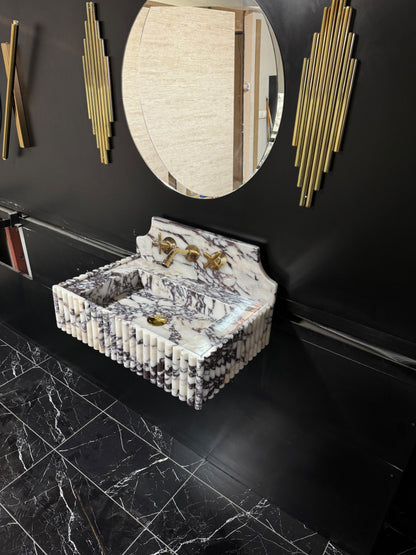 Full Ribbed Calacatta Viola Marble Sink, featuring fluted detailing on all sides for a bold architectural look. Handcrafted from premium Viola marble, this floating rectangular basin is paired with a custom Calacatta marble backsplash, creating a harmonious, luxury aesthetic