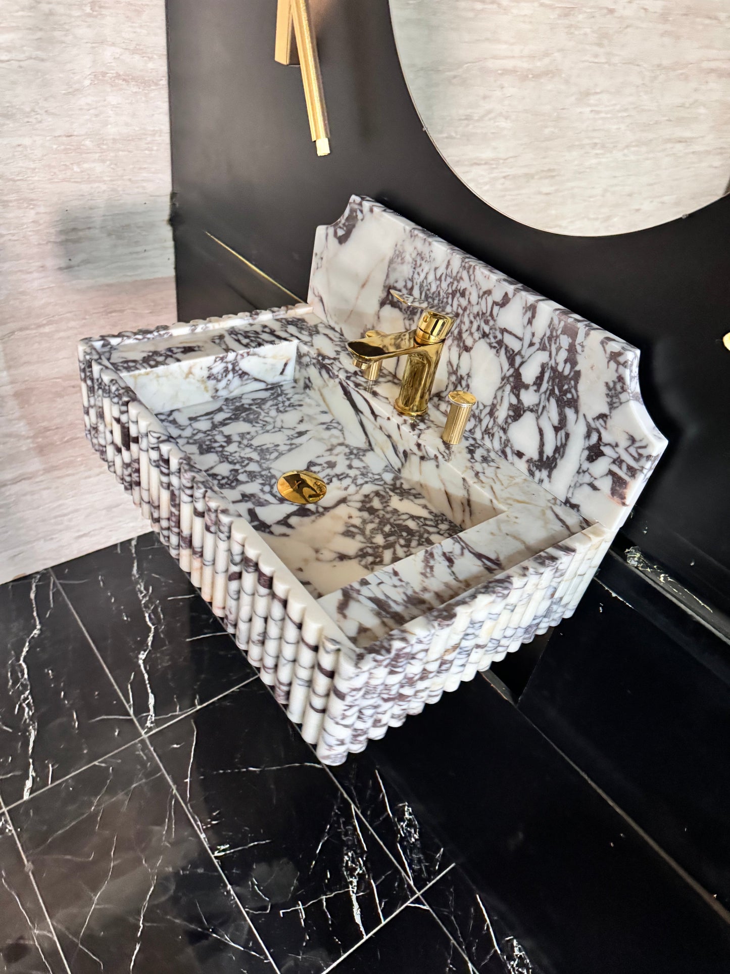 Full Ribbed Calacatta Viola Marble Sink, featuring fluted detailing on all sides for a bold architectural look. Handcrafted from premium Viola marble, this floating rectangular basin is paired with a custom Calacatta marble backsplash, creating a harmonious, luxury aesthetic
