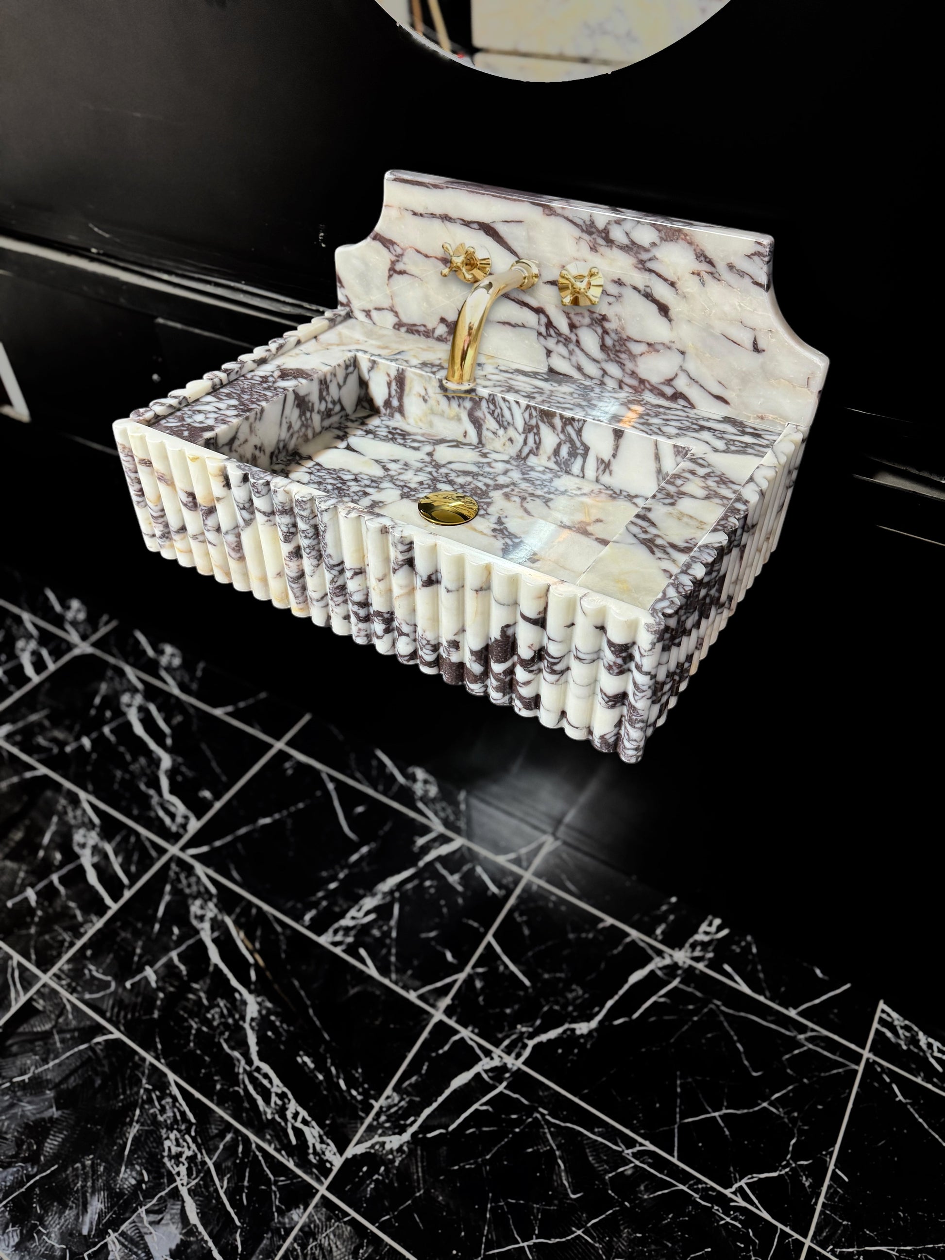 Full Ribbed Calacatta Viola Marble Sink, featuring fluted detailing on all sides for a bold architectural look. Handcrafted from premium Viola marble, this floating rectangular basin is paired with a custom Calacatta marble backsplash, creating a harmonious, luxury aesthetic